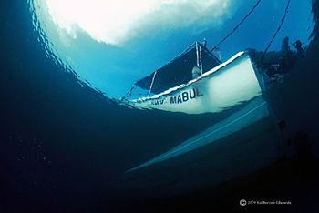 Mabul island dive boat from under the jetty, 16mm fisheye... by Katherine Edwards 
